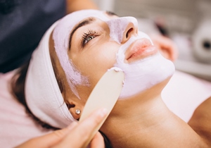 Opelika Alabama esthetician applying facial cream to woman's face
